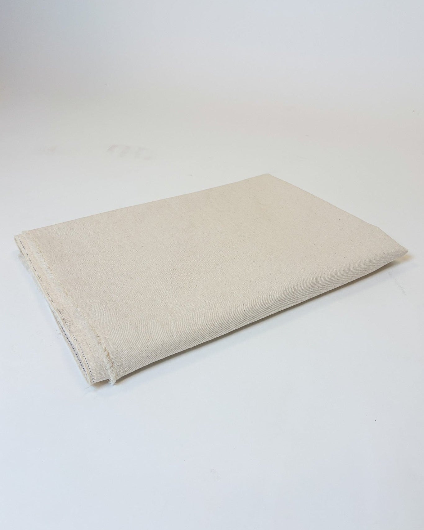 Beige fabric square on a white background
