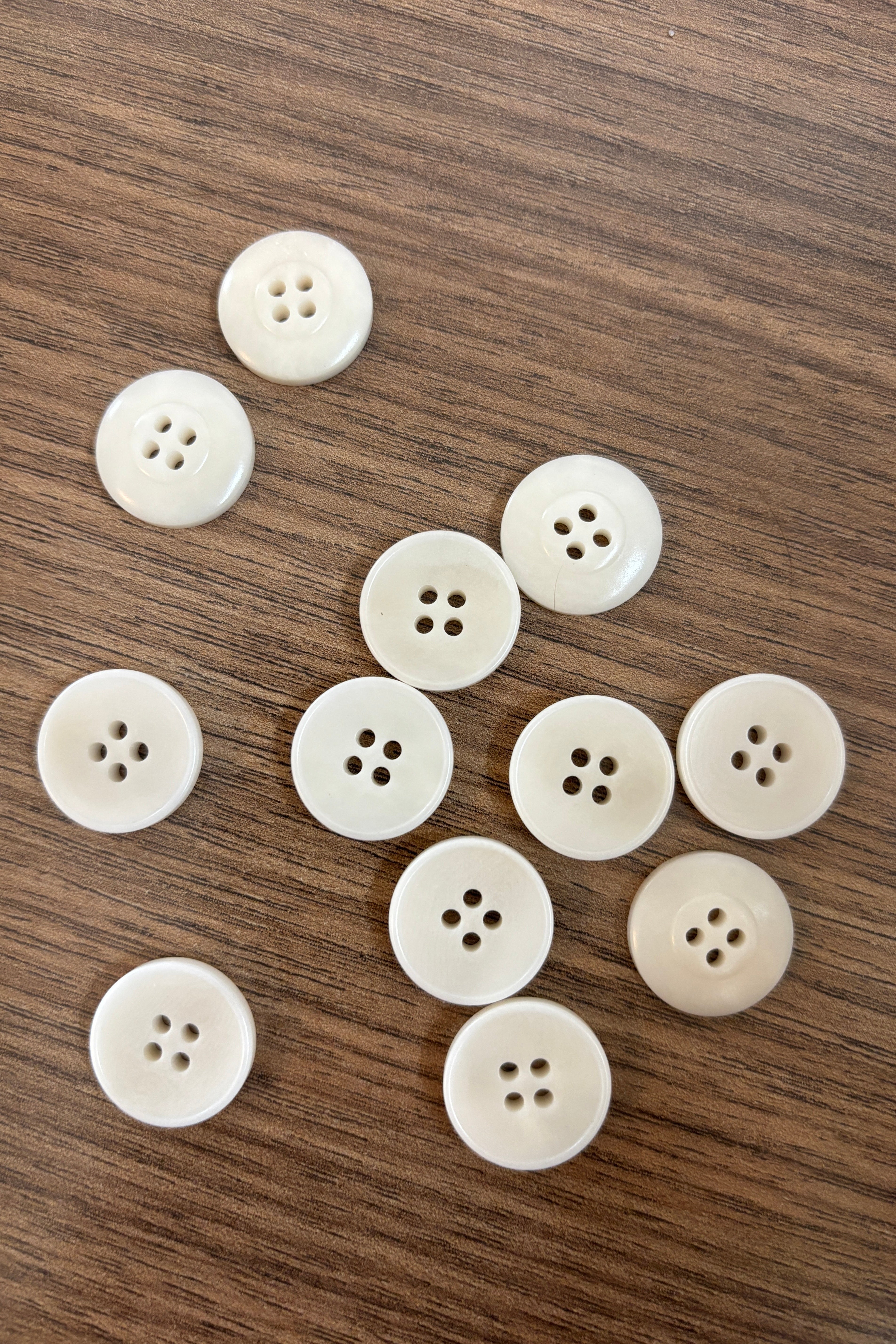 White buttons on a wooden surface- corozo buttons